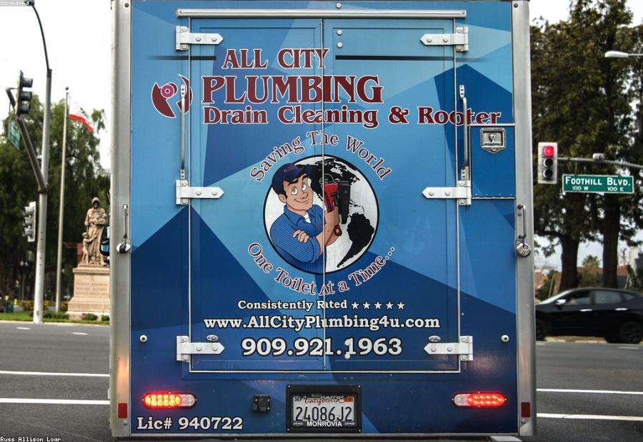 Licensed technician explaining an upfront flat-rate plumbing quote to a homeowner