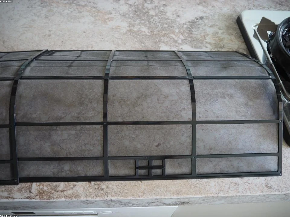 Clean pleated AC filter next to the dust-loaded one it replaced in a Dallas home